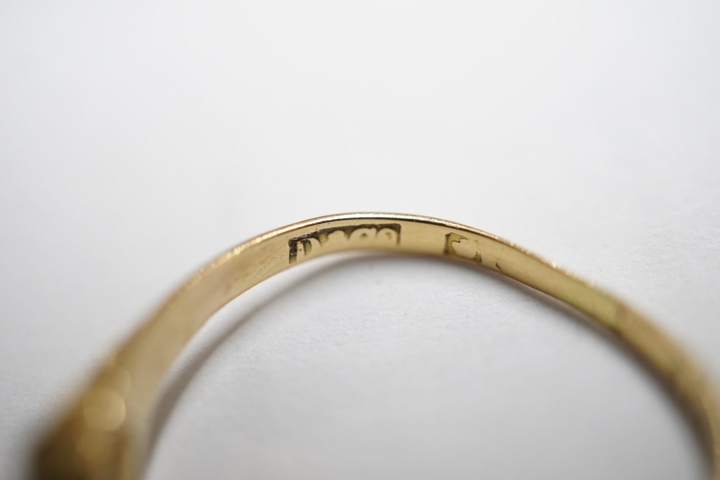 An early 20th century yellow metal and three stone sapphire set half hoop ring, the central stone bordered with rose cut diamonds, size M, gross weight 3 grams.